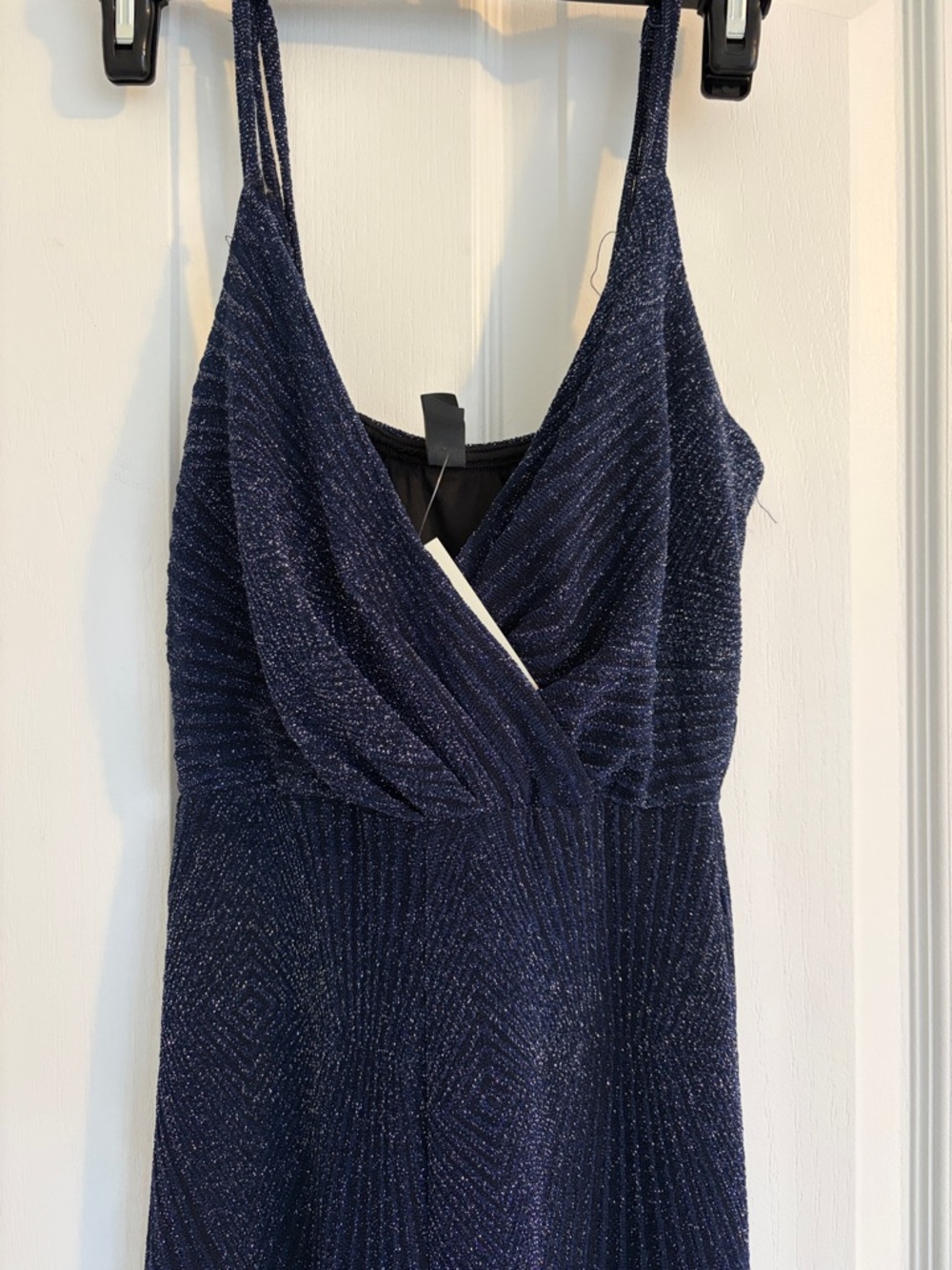 Francescas  dark blue jumpsuit with a shimmering finish.